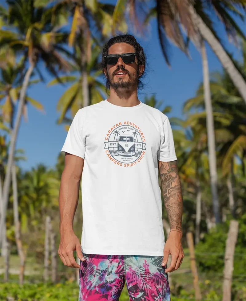 t shirt mockup of a man with surfer shorts standing at the beach 26755